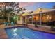 Beautiful pool area with a screened porch and comfortable outdoor seating, perfect for entertaining at 235 Aberdeen St, Dunedin, FL 34698