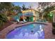 Inviting backyard oasis featuring a sparkling pool, tiki bar, upper deck and lounge area perfect for entertaining at 235 Aberdeen St, Dunedin, FL 34698