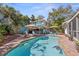 Beautiful backyard featuring a pool, tiki bar, and deck, ideal for outdoor entertaining and relaxation at 235 Aberdeen St, Dunedin, FL 34698