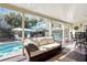 Inviting screened porch with comfortable seating overlooking the pool and outdoor entertaining area at 235 Aberdeen St, Dunedin, FL 34698