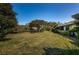 Sprawling backyard with lush grass, mature trees, and well-maintained landscaping at 2749 Countryside Blvd # 28, Clearwater, FL 33761