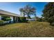 Lush green backyard with a screened-in porch and mature landscaping, offering privacy at 2749 Countryside Blvd # 28, Clearwater, FL 33761