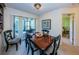 Dining room with a dark wood table, access to the screened patio, and views of the bedroom at 2749 Countryside Blvd # 28, Clearwater, FL 33761