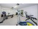 Another view of the home exercise room featuring exercise machines, free weights and a wall mirror at 2749 Countryside Blvd # 28, Clearwater, FL 33761