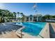 Community pool with beautiful landscaping and lounge chairs for relaxation at 2749 Countryside Blvd # 28, Clearwater, FL 33761