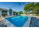 Community pool with pristine, clear water and lounge chairs ready for relaxing at 2749 Countryside Blvd # 28, Clearwater, FL 33761