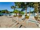 Picturesque view of the poolside area, complete with comfortable lounge chairs and lush tropical greenery at 2749 Countryside Blvd # 28, Clearwater, FL 33761