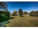 Expansive lawn with mature trees and landscaping, offering a serene outdoor space at 2749 Countryside Blvd # 28, Clearwater, FL 33761