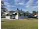 Classic single-story home with gray exterior, awning-covered windows, and a well-maintained lawn at 3001 57Th S St, Gulfport, FL 33707