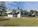 Charming single-story home with awning-covered windows, a gray roof, and a well-maintained lawn at 3001 57Th S St, Gulfport, FL 33707