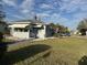 Classic single-story home featuring a well-manicured lawn, gray exterior and awning-covered windows at 3001 57Th S St, Gulfport, FL 33707