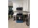Kitchen with white cabinets, stainless steel appliances, and open space where flooring once was at 3001 57Th S St, Gulfport, FL 33707
