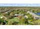 Aerial view of expansive resort with pool, golf course, lush greenery, and multiple buildings on a clear day at 36750 Us Highway 19 N # 3-210, Palm Harbor, FL 34684