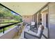 Balcony features seating with a view of lush green spaces and landscaping at 36750 Us Highway 19 N # 3-210, Palm Harbor, FL 34684