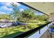 Balcony with a view of the community featuring lush landscaping, and parking at 36750 Us Highway 19 N # 3-210, Palm Harbor, FL 34684