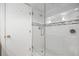 Tiled bathroom showcasing a glass shower door and white subway tile with decorative accents at 36750 Us Highway 19 N # 3-210, Palm Harbor, FL 34684