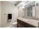 Bathroom features a granite countertop vanity, and a large mirror with decorative lighting at 36750 Us Highway 19 N # 3-210, Palm Harbor, FL 34684