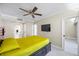 Bedroom featuring tile flooring, ceiling fan, and easy access to bathroom at 36750 Us Highway 19 N # 3-210, Palm Harbor, FL 34684