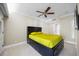 Bright bedroom featuring a ceiling fan, neutral walls, and a platform bed with built-in storage at 36750 Us Highway 19 N # 3-210, Palm Harbor, FL 34684
