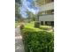 Condo complex surrounded by lush green grass and well-maintained landscaping at 36750 Us Highway 19 N # 3-210, Palm Harbor, FL 34684