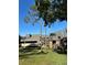 Brick condo building featuring a unique roofline and lush landscaping, inviting you to your new home at 36750 Us Highway 19 N # 3-210, Palm Harbor, FL 34684