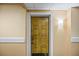 Close-up of a unit's front door, number 2378, with light fixture and neutral colored walls at 36750 Us Highway 19 N # 3-210, Palm Harbor, FL 34684