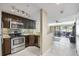 Open-concept kitchen with stainless appliances flows into the dining and living areas and sliding glass door at 36750 Us Highway 19 N # 3-210, Palm Harbor, FL 34684