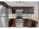 Updated kitchen with stainless steel appliances, stylish backsplash, and granite countertops at 36750 Us Highway 19 N # 3-210, Palm Harbor, FL 34684