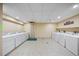 Community laundry room featuring multiple washing machines for convenient use at 36750 Us Highway 19 N # 3-210, Palm Harbor, FL 34684