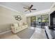 Comfortable living room with modern furnishings, tile floors, and a view of the outdoors from the balcony at 36750 Us Highway 19 N # 3-210, Palm Harbor, FL 34684