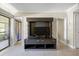 Modern living room with an entertainment center and doors leading to the entry and balcony at 36750 Us Highway 19 N # 3-210, Palm Harbor, FL 34684