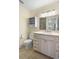 Updated bathroom with white cabinetry and modern lighting at 407 Feltham Trl # A, Sun City Center, FL 33573