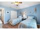 Inviting bedroom showcasing two twin beds, hardwood floors, and beach themed decor at 407 Feltham Trl # A, Sun City Center, FL 33573