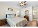 Bright bedroom with hardwood floors, ceiling fan, and ensuite bathroom access, offering a private retreat at 407 Feltham Trl # A, Sun City Center, FL 33573