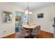 Cozy dining area with hardwood floors and sliding glass doors leading to a screened lanai for outdoor dining at 407 Feltham Trl # A, Sun City Center, FL 33573