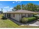 Charming single-story home features red shutters, a well-maintained lawn and walkway, and a cozy screened porch at 407 Feltham Trl # A, Sun City Center, FL 33573