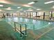 Bright indoor swimming pool featuring multiple windows at 407 Feltham Trl # A, Sun City Center, FL 33573