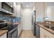 Well-equipped kitchen features stainless steel appliances, tile backsplash, and neutral cabinetry with ample storage at 407 Feltham Trl # A, Sun City Center, FL 33573