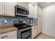 Well-equipped kitchen with stainless steel appliances and unique backsplash tiling at 407 Feltham Trl # A, Sun City Center, FL 33573