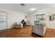 Cozy living room with hardwood floors, access to the lanai, neutral decor, and comfortable seating for relaxation at 407 Feltham Trl # A, Sun City Center, FL 33573