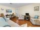 Spacious living room with neutral decor, hardwood floors, and ample seating for entertaining or relaxing with Gathering at 407 Feltham Trl # A, Sun City Center, FL 33573