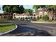 View of a parking area with several golf carts parked near a clubhouse at 407 Feltham Trl # A, Sun City Center, FL 33573
