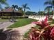 Clubhouse with swimming pool, chairs, and landscaping at 407 Feltham Trl # A, Sun City Center, FL 33573