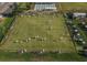 Aerial shot of a large lawn with recreational activities and golf carts at 407 Feltham Trl # A, Sun City Center, FL 33573
