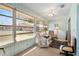 Bright sunroom featuring multiple windows and comfortable seating area at 407 Feltham Trl # A, Sun City Center, FL 33573