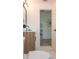 Neutral toned bathroom with marble tile, decorative mirror, and modern sink and fixture at 4586 12Th N Ave, St Petersburg, FL 33713