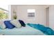 Bright bedroom with a cozy bed dressed in soft blue tones near a sunny window at 4586 12Th N Ave, St Petersburg, FL 33713
