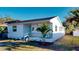 Charming white home featuring a quaint front porch and beautiful landscaping at 4586 12Th N Ave, St Petersburg, FL 33713