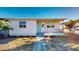 Charming single-story home featuring a covered front porch, a neatly landscaped yard, and a light blue front door at 4586 12Th N Ave, St Petersburg, FL 33713