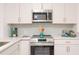 Modern kitchen featuring stainless steel appliances, sleek white cabinets, and stylish hardware for a contemporary look at 4586 12Th N Ave, St Petersburg, FL 33713